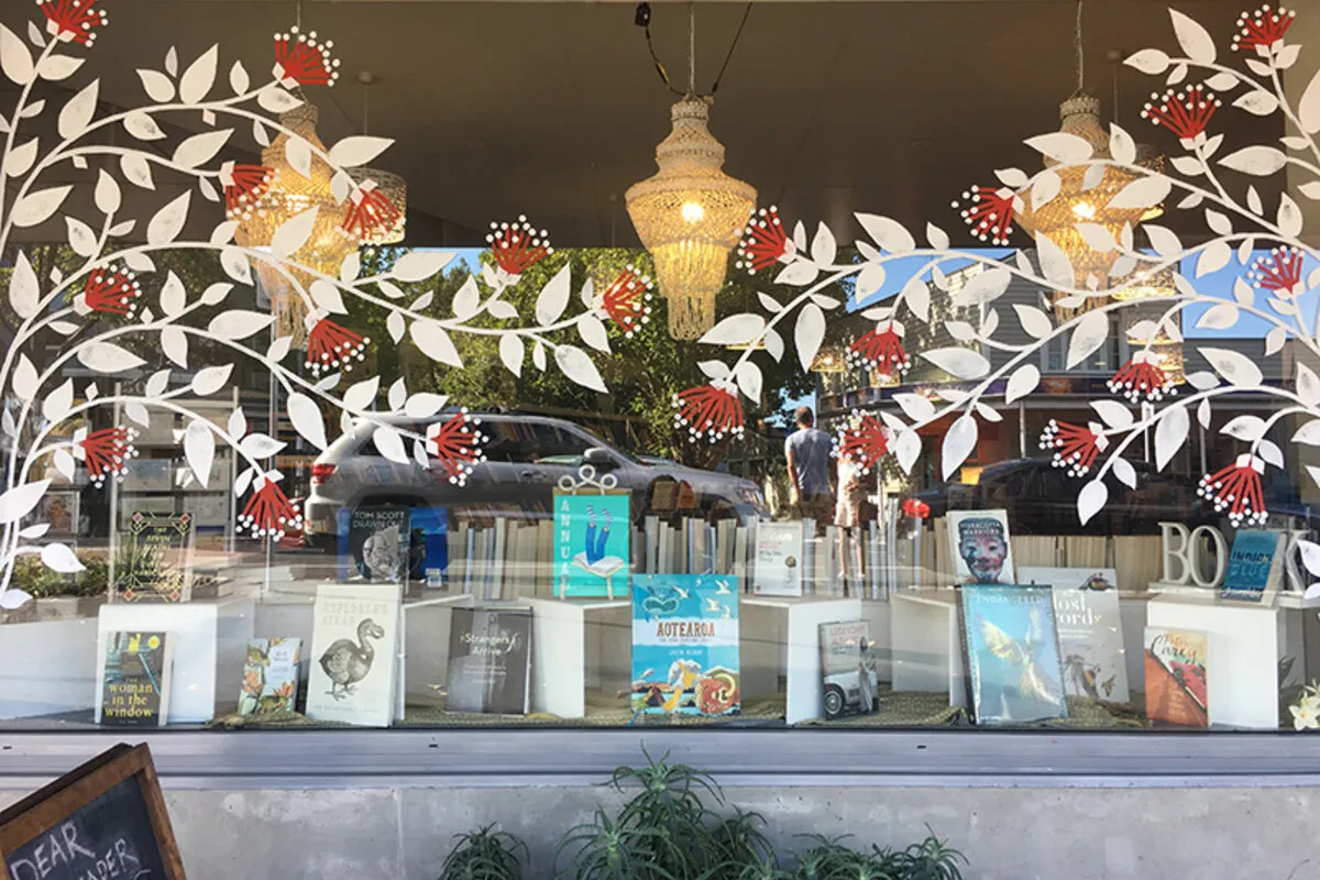 The warmly lit window display at Dear Reader bookshop