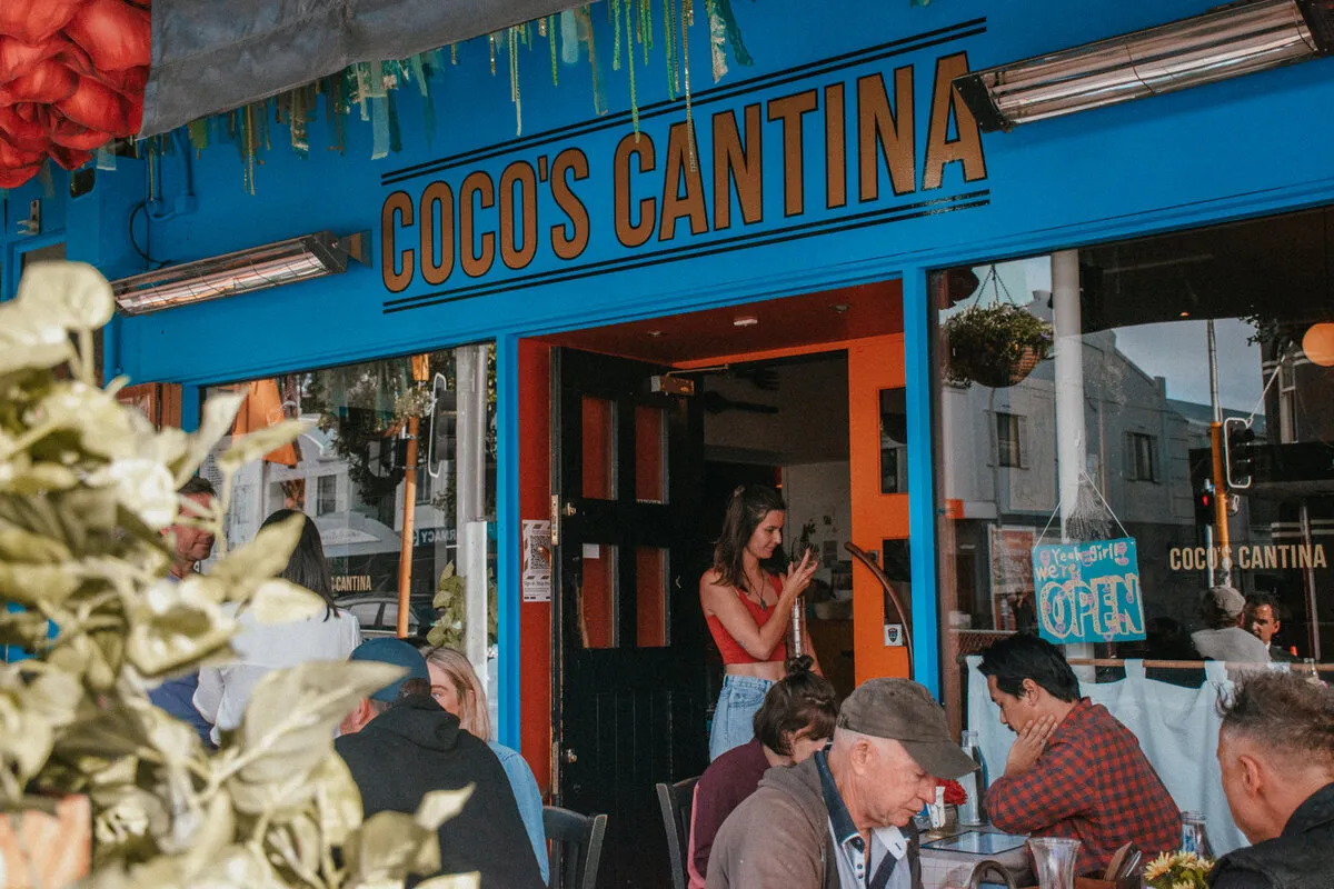 Diners enjoying pasta and pizza at Coco’s Cantina