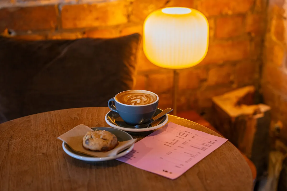 Brick-walled interior of Open coffee shop on K’ Road
