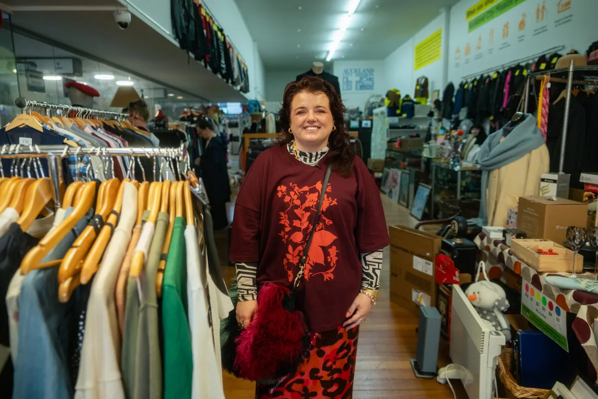 Evie Kemp browsing racks at the Auckland City Mission Op Shop
