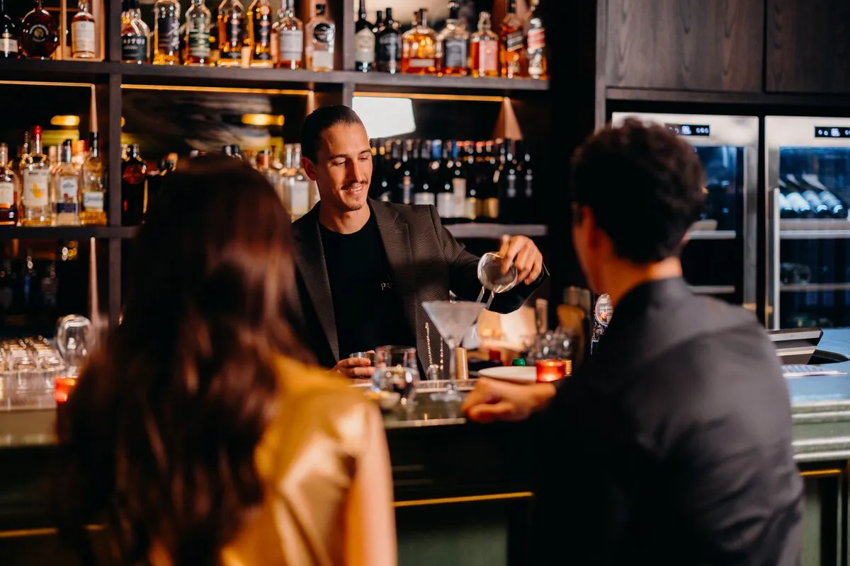 Juan Isola preparing a cocktail behind the Alla Prossima bar