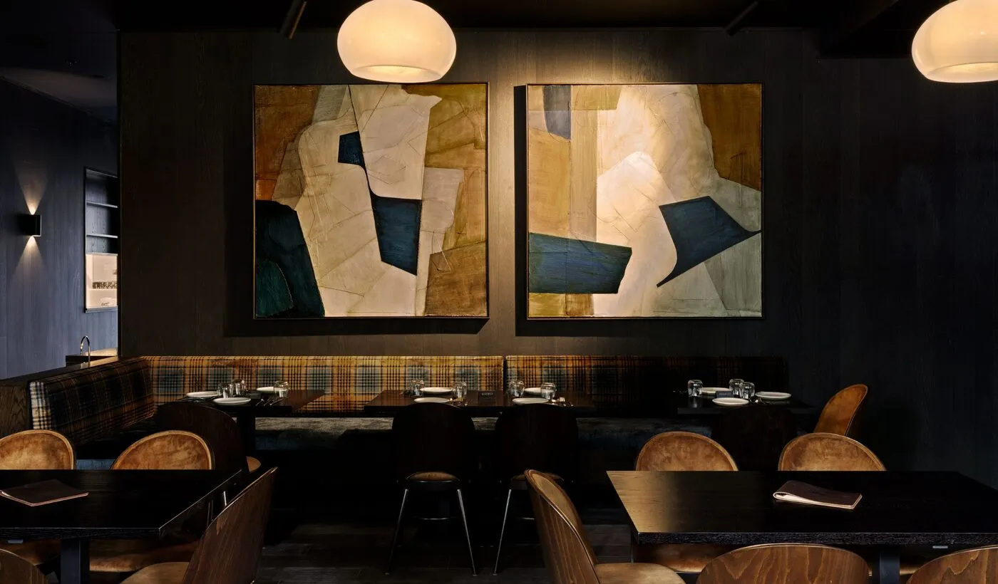 The Alla Prossima dining room with abstract artwork and warm lighting